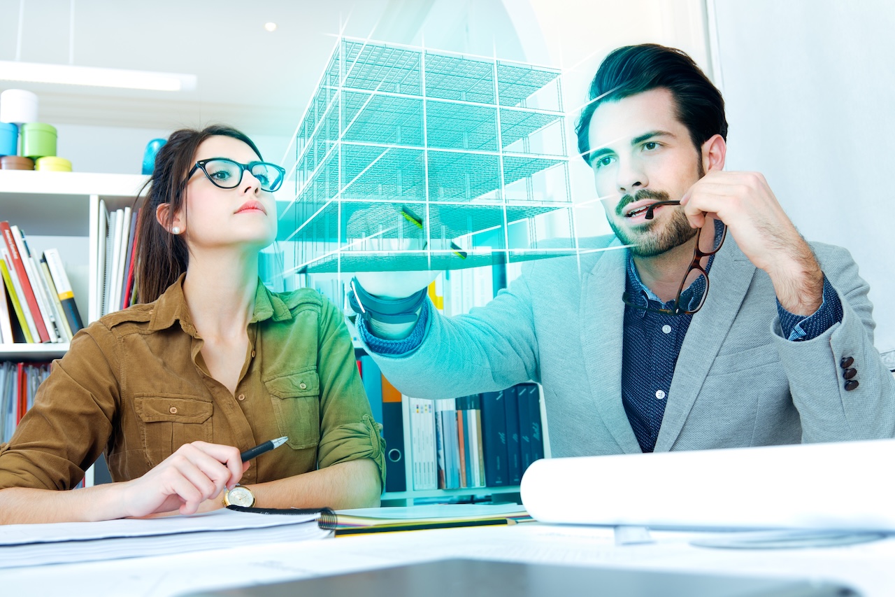 Professionisti del settore costruzioni analizzano un modello BIM digitale in ambiente collaborativo CDE, simbolo della gestione avanzata dei dati nei progetti digitali